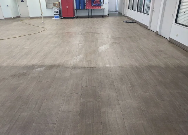 Tufts LVP cleaning in progress on a gray plank floor