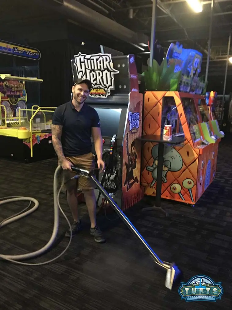 Cheyenne smiling beside cleaning equipment on a commercial carpet-cleaning job