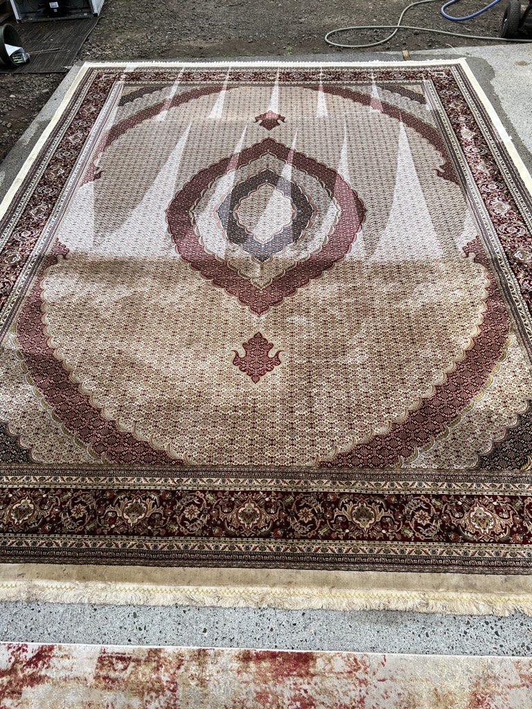 Area rug being inspected for appropriate in-home cleaning