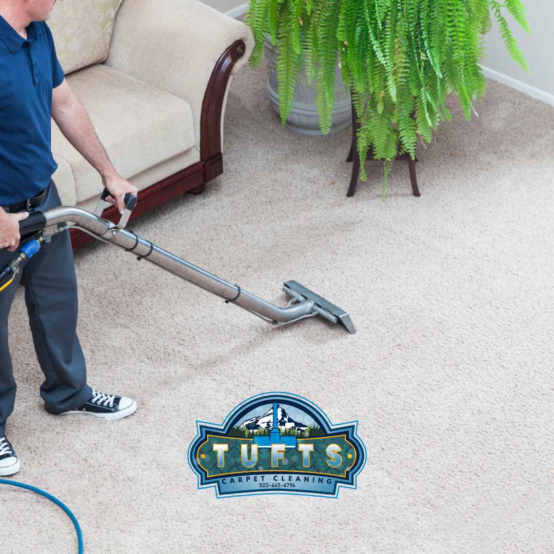 Tufts Carpet Cleaning technician cleaning carpet inside a customer's home